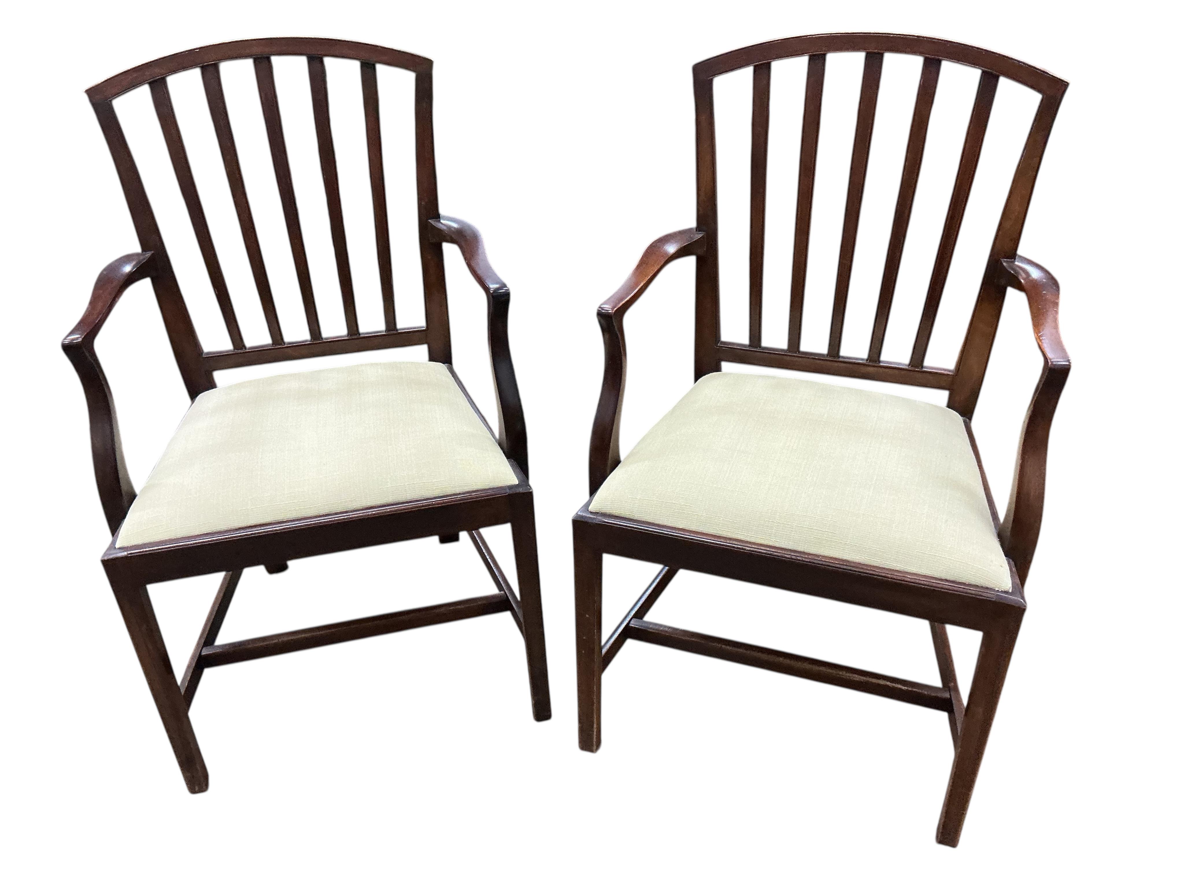 A set of six George III mahogany dining chairs with two matching later elbow chairs